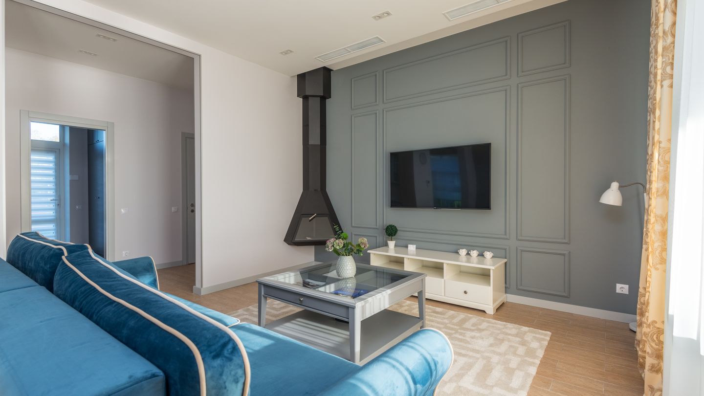 A wall-mounted television in a finished living room